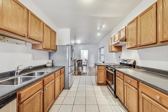 kitchen featuring sink, appliances with stainless steel finishes, rail lighting, and light tile patterned floors