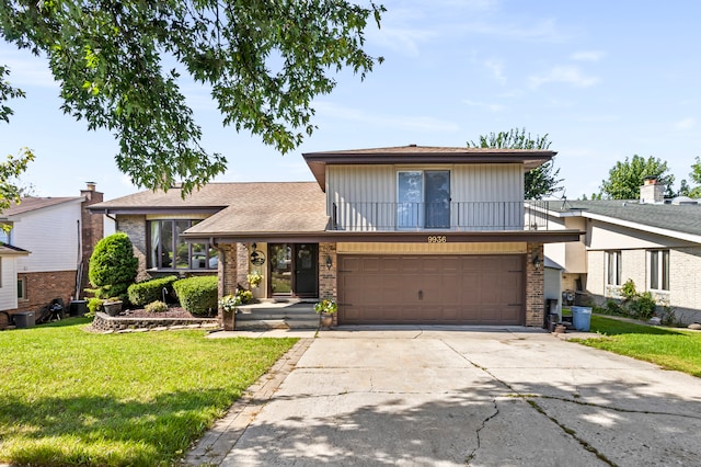 view of front of property with a front lawn and a garage