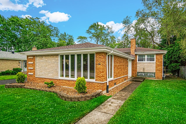 rear view of house with a yard