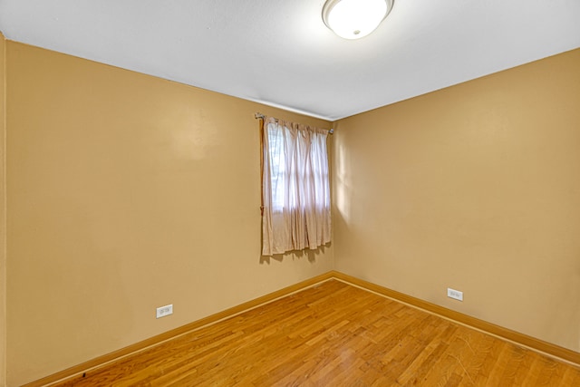 empty room with wood-type flooring