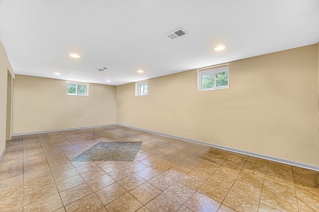 basement with a wealth of natural light and light tile patterned floors