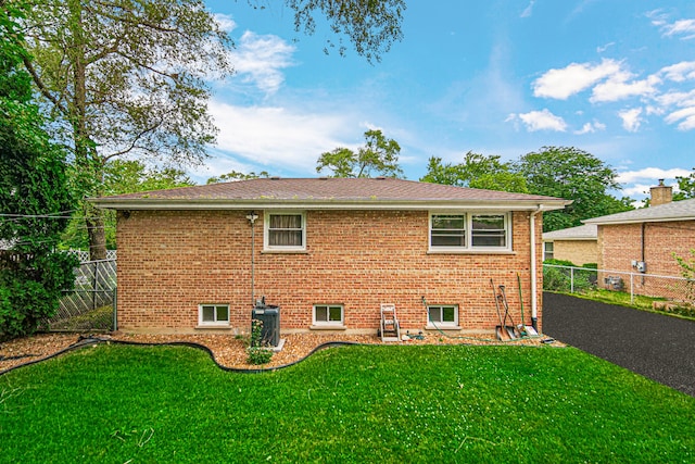 back of house with a lawn