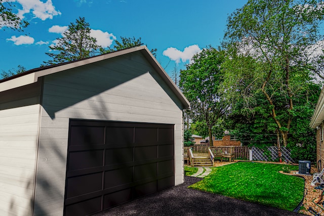 garage featuring central AC and a lawn