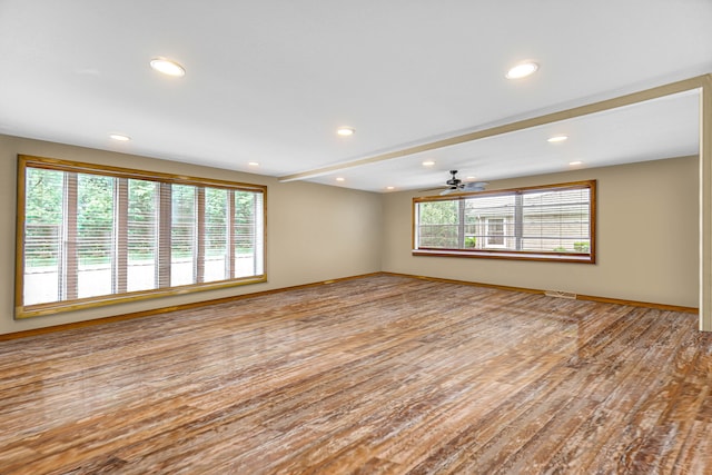 unfurnished room featuring light wood-type flooring and ceiling fan