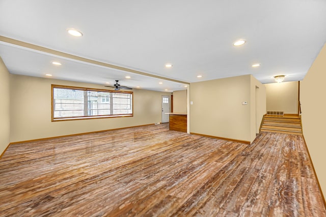 unfurnished living room with ceiling fan and light wood-type flooring