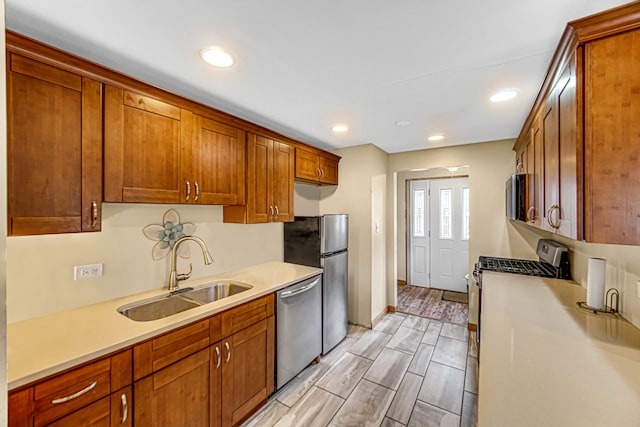 kitchen featuring sink, appliances with stainless steel finishes, and light hardwood / wood-style floors