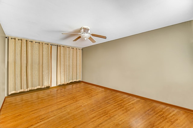 empty room featuring hardwood / wood-style floors and ceiling fan