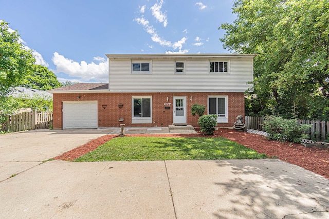 front of property featuring a front lawn and a garage