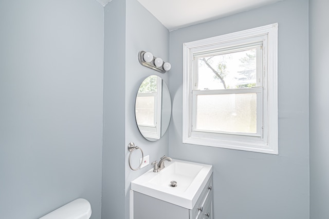 bathroom featuring vanity and toilet