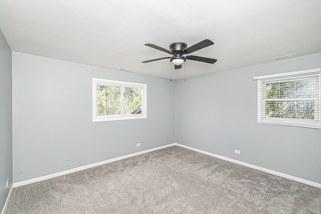 carpeted spare room featuring ceiling fan