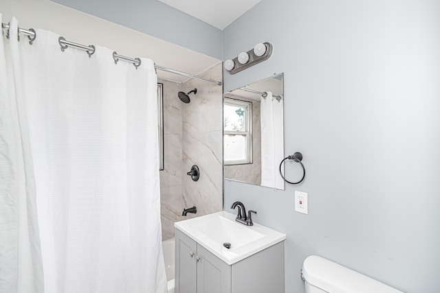 full bathroom featuring vanity, shower / tub combo, and toilet