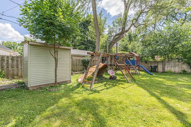 view of yard featuring a playground and a storage shed