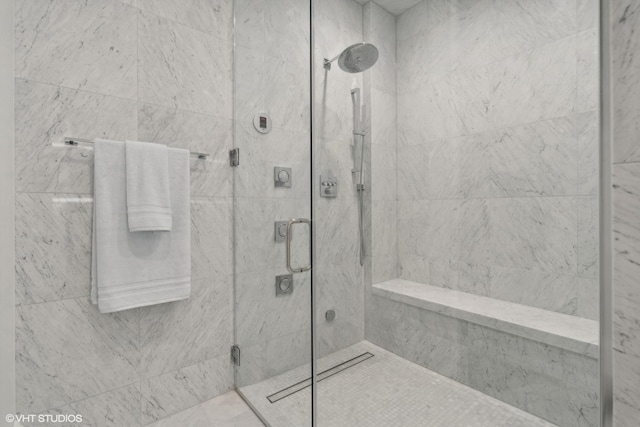 bathroom with a shower with door