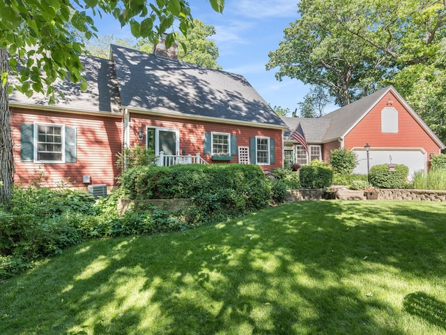 new england style home with cooling unit and a front yard