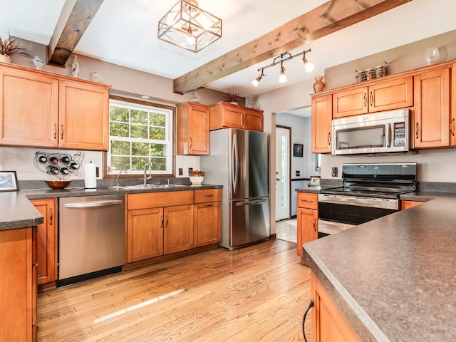 kitchen featuring light wood-type flooring, beamed ceiling, stainless steel appliances, and decorative light fixtures