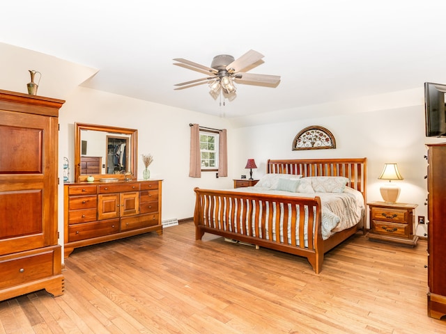 bedroom with light hardwood / wood-style floors and ceiling fan