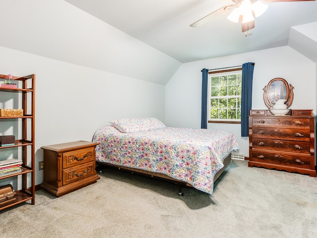 bedroom with vaulted ceiling, ceiling fan, and carpet flooring