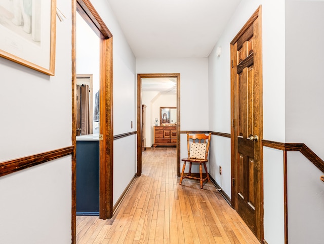 corridor with light hardwood / wood-style flooring