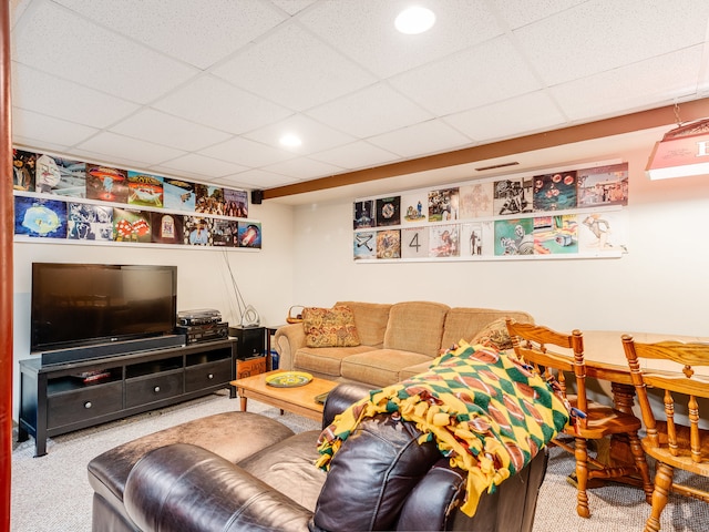 living room featuring a paneled ceiling and carpet flooring