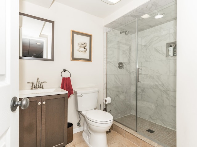 bathroom featuring vanity, a shower with shower door, toilet, and tile patterned flooring