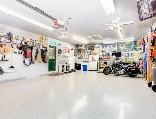 garage with a garage door opener and ceiling fan