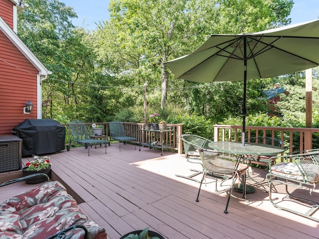 wooden deck with a grill