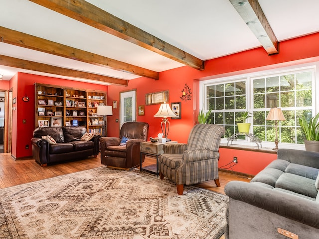 living room featuring beam ceiling and hardwood / wood-style flooring