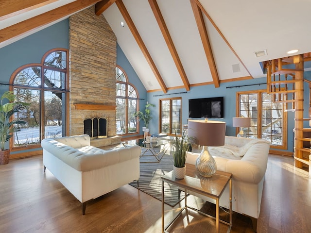 living room with a fireplace, high vaulted ceiling, beam ceiling, and hardwood / wood-style floors