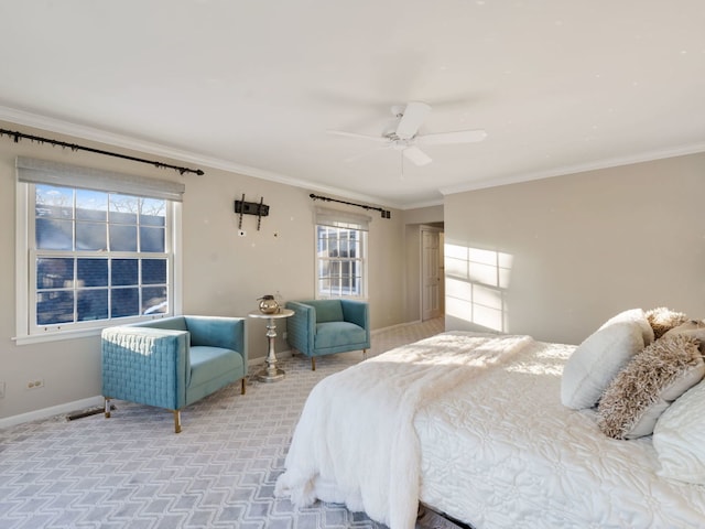 bedroom with carpet floors, ceiling fan, crown molding, and multiple windows