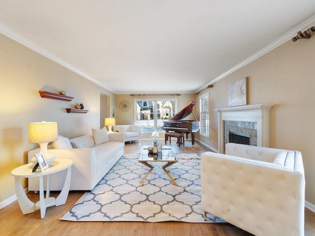 living room with hardwood / wood-style floors, a tiled fireplace, and ornamental molding