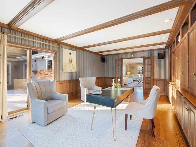 interior space featuring french doors, ornamental molding, light hardwood / wood-style floors, and beam ceiling