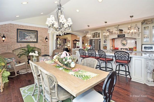 dining area with decorative columns, ornamental molding, dark hardwood / wood-style flooring, and vaulted ceiling