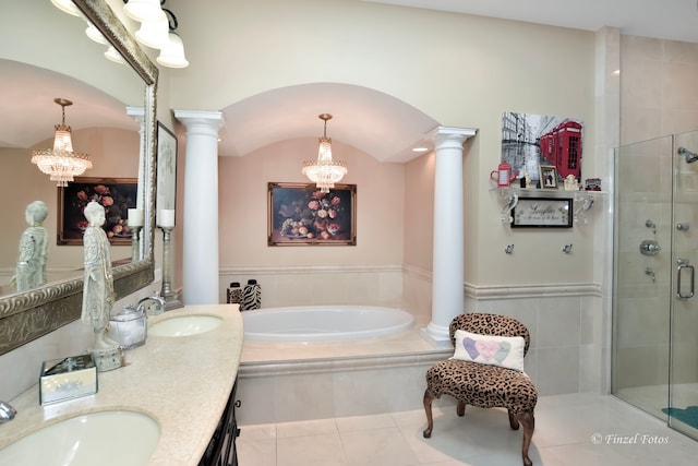 bathroom with a chandelier, decorative columns, tile patterned floors, and separate shower and tub