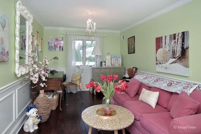 living room with an inviting chandelier, hardwood / wood-style floors, and ornamental molding