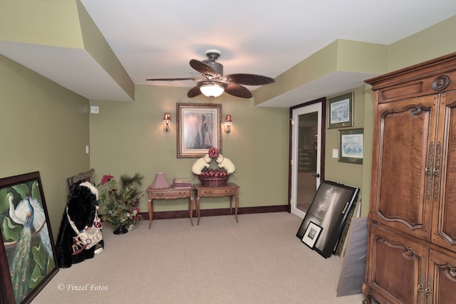 living area featuring ceiling fan and light colored carpet