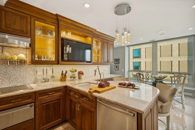 kitchen with dishwasher, sink, hanging light fixtures, a kitchen breakfast bar, and backsplash