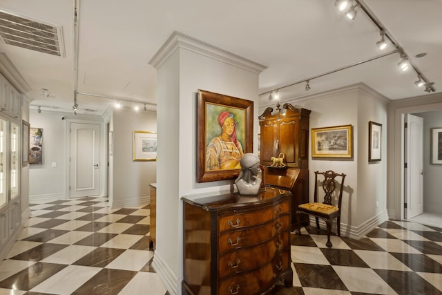 corridor with rail lighting and crown molding