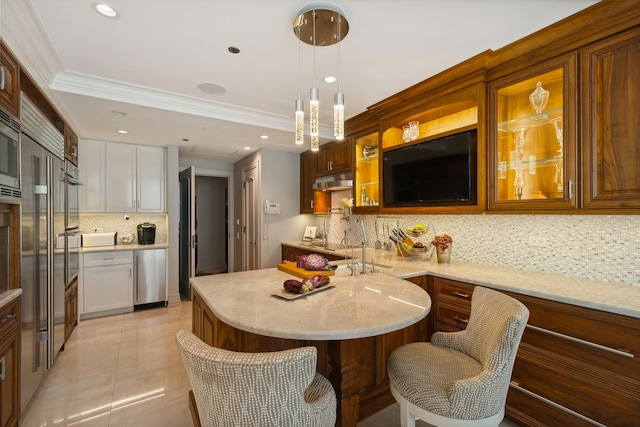 kitchen featuring pendant lighting, tasteful backsplash, a breakfast bar area, light tile patterned floors, and ornamental molding