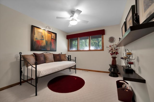 sitting room featuring ceiling fan and carpet flooring