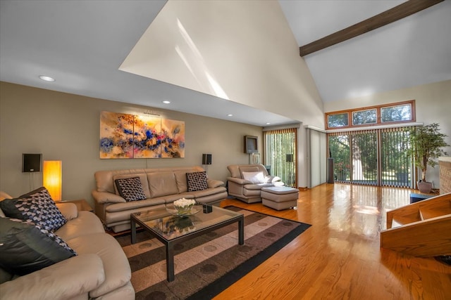 living room featuring beam ceiling, high vaulted ceiling, and hardwood / wood-style flooring