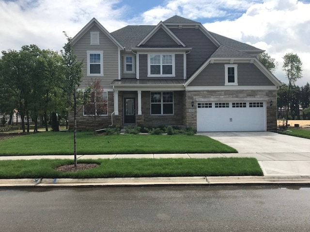 craftsman-style home featuring a garage and a front yard