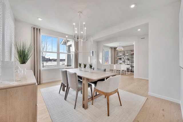 dining room featuring light hardwood / wood-style floors and a chandelier