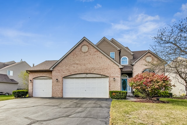 view of front of property featuring a garage and a front lawn