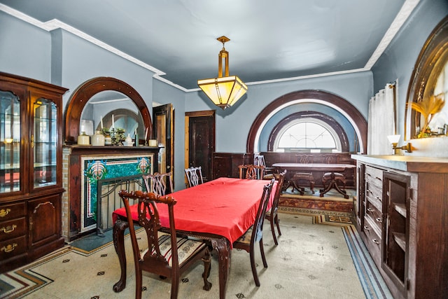 dining space with crown molding, carpet flooring, and a high end fireplace