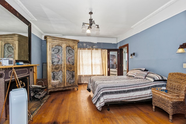 bedroom featuring crown molding and wood-type flooring