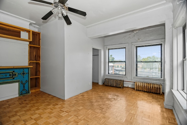 unfurnished living room featuring ceiling fan, radiator, and light parquet flooring