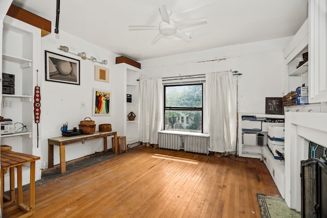 interior space featuring radiator heating unit, hardwood / wood-style floors, and ceiling fan