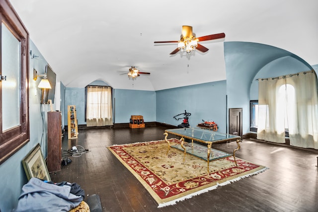 recreation room with lofted ceiling, ceiling fan, and dark wood-type flooring