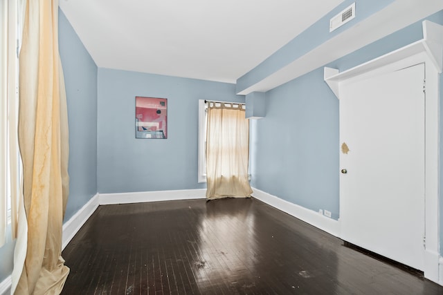 empty room with dark wood-type flooring