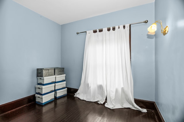 unfurnished room featuring dark hardwood / wood-style flooring